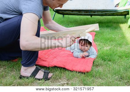 Girl Feeds A Little Pig. In A Green Meadow. The Concept Of Sustainability, Love Of Nature, Respect F