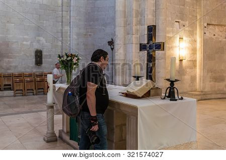 Jerusalem, Israel, September 07, 2019 : A Visitor Reviews Scripture In The Lutheran Church Of The Re