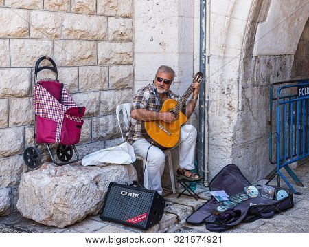 Jerusalem, Israel, September 07, 2019 : Street Musician Plays Guitar On Muristan Street In The Old C