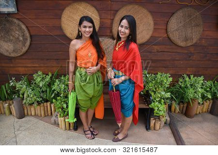 Kanchanaburi, Thailand, 09.09.2019: Beautiful Thai Girls In Traditional Thai, Siamese Dress With Gre