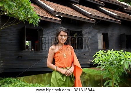 Kanchanaburi, Thailand, 09.09.2019: Beautiful Thai Girl In Traditional Thai, Siamese Dress With Gree