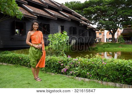 Kanchanaburi, Thailand, 09.09.2019: Beautiful Thai Girl In Traditional Thai, Siamese Dress With Gree