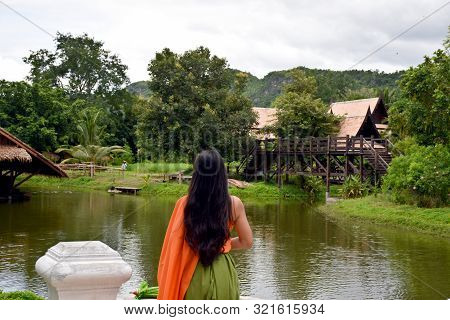 Kanchanaburi, Thailand, 09.09.2019: Beautiful Thai Girl In Traditional Thai, Siamese Dress With Gree