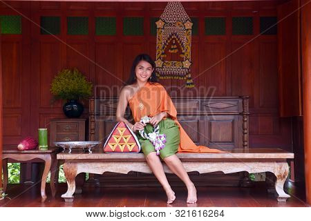 Kanchanaburi, Thailand, 09.09.2019: Beautiful Thai Girl In Traditional Thai, Siamese Dress With Gree