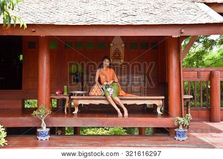 Kanchanaburi, Thailand, 09.09.2019: Beautiful Thai Girl In Traditional Thai, Siamese Dress With Gree