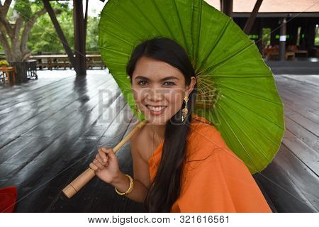 Kanchanaburi, Thailand, 09.09.2019: Beautiful Thai Girl In Traditional Thai, Siamese Dress With Gree