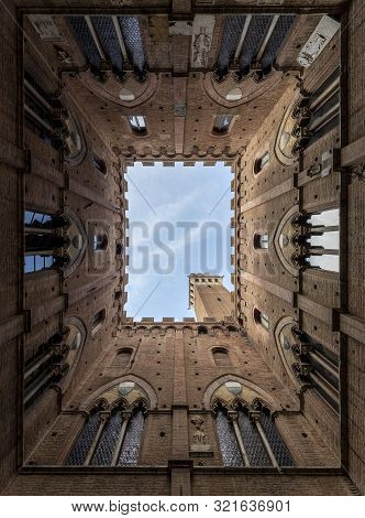 View Of The Torre Del Mangia And From Inside The Cortile Del Podestà Near The Public Palace Of Siena