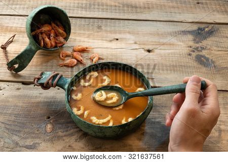 Tasting Food. Hand And Dish. Hand And Utensils. A Man Eats Soup.