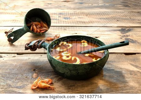 Red Shrimp Soup. Cooked Shrimp And Soup. Wooden Background.