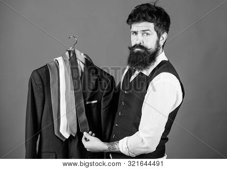 Which Tie Should I Wear. Bearded Man Matching Neck Tie Color To Coat. Brutal Hipster Holding Colorfu
