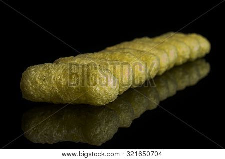 Lot Of Whole Salted Yellow Corn Puff Isolated On Black Glass