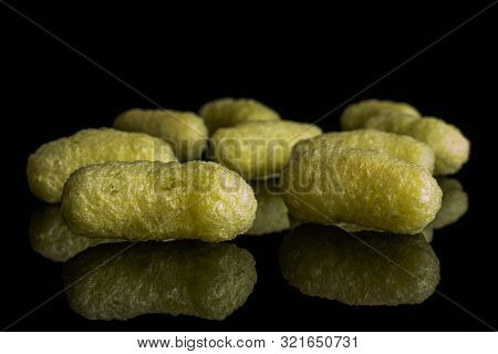Group Of Nine Whole Salted Yellow Corn Puff Isolated On Black Glass