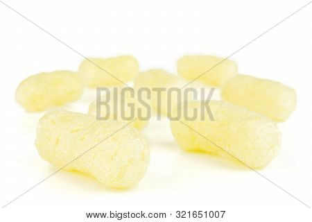Group Of Eight Whole Salted Yellow Corn Puff Isolated On White Background
