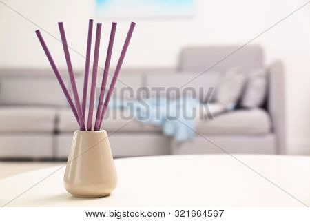 Reed Air Freshener With Essential Oil On Table In Room. Space For Text