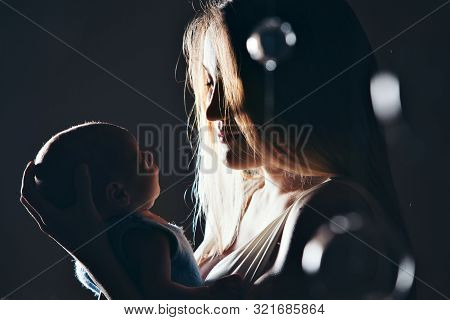 The Concept Of Parenthood, Childrens Day, Medicine, Ivf-mother Looks At The Sleeping Newborn. Shadow