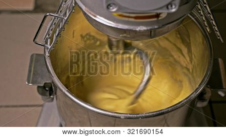 Mixing Dough For Bread Baking With Professional Kneader Spiral Machine At The Manufacturing. The Dou