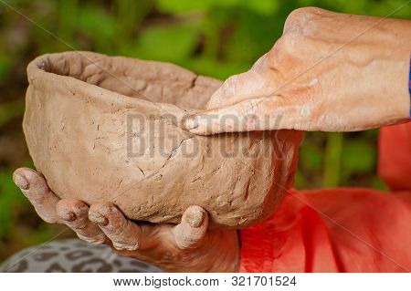 Making Clay Dishes Manually. Big Hands. On The Street