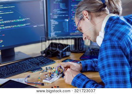 Developer Is Connecting Breadboard To Microcontroller For Creating Prototype Of Electronic Device. C