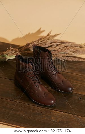 Stylish Fashion Shoes Boots Footwear Concept On Brown Wooden Background. Urban Footwear Advertising
