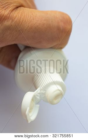 Woman's Hands Squeezing Toothpaste On White Background, Close Up & Macro Shot, Selective Focus, Heal
