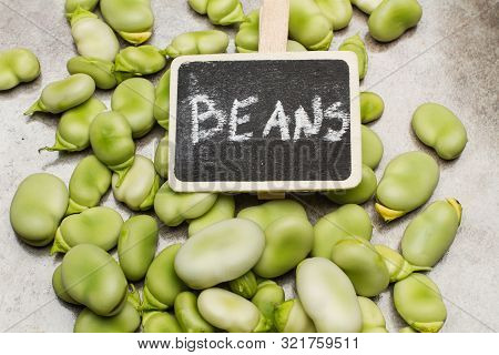 Broad Beans On A Marble Table With A Sign