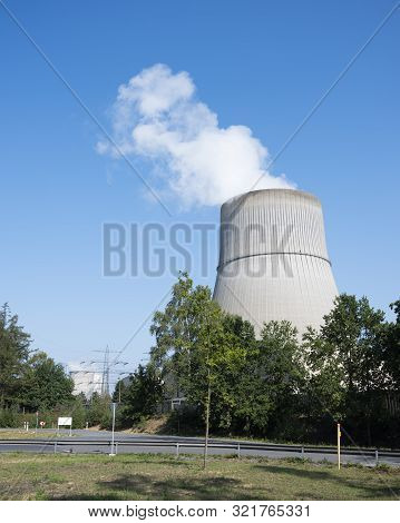 Steam And Blue Sky Above Large Chimney Of Nuclear Power Plant Near German Town Lingen In Lower Saxon