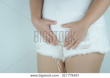 Woman Having Painful Stomachache With Hands Holding Pressing Her Crotch Lower Abdomen. Medical Or Gy