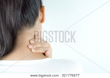Closeup Woman Suffering From Neck And Shoulder Pain On Grey Background.. Health Care And Medical Con