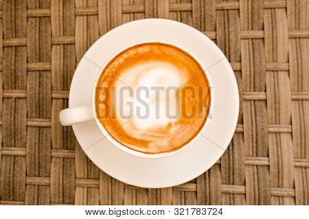 Cappuccino In White Cup On Cane Wood Table At Cafe. Top View. Copyspace. Bewerages, Coffee Lovers An