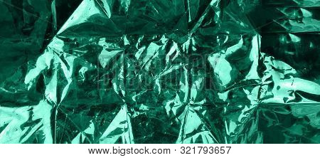 Green Shiny Metallic Foil Texture. Beautiful Background For Your Design.