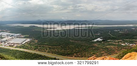 Aerial Panoramic View Of Suburbs Of Gaborone City Surrounded By Savannah And Lake In The Background,