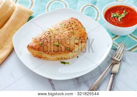Italian Pastry Pepperoni And Cheese Calzone With Tomato Marinara Dipping Sauce