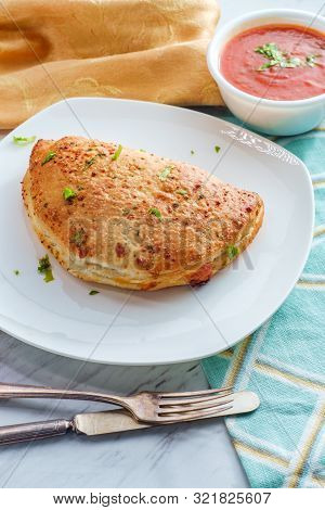 Italian Pastry Pepperoni And Cheese Calzone With Tomato Marinara Dipping Sauce