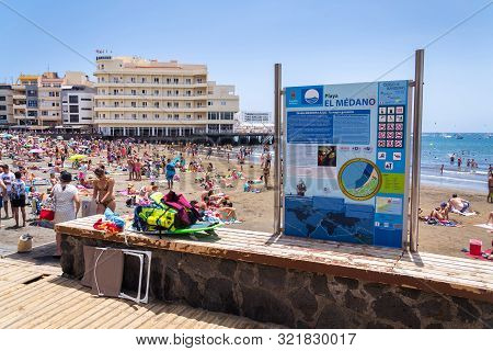 El Medano, Spain - July 7 2019: People Swimming And Sunbathing On Playa El Medano Beach On July 7, 2