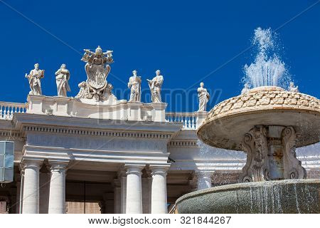 Fountain And Detail Of The Chigi Coats Of Arms And The Statues Of Saints That Crown The Colonnades O