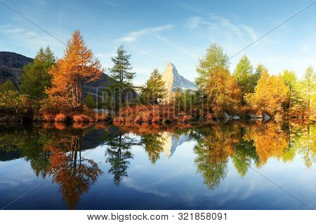 Incredible colorful sunrise on Grindjisee lake with Matterhorn Cervino peak in Swiss Alps. Zermatt resort location, Switzerland. Landscape photography