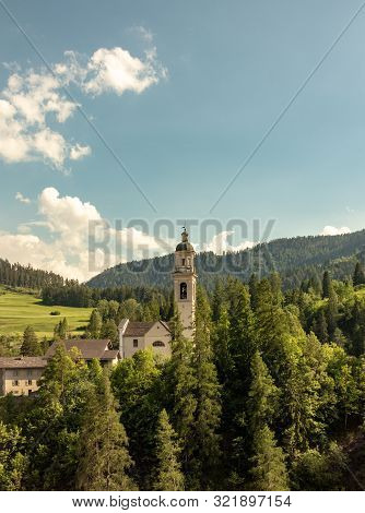 Old Church On A Wooded Mountain At Blue Sky In The Swiss Alps