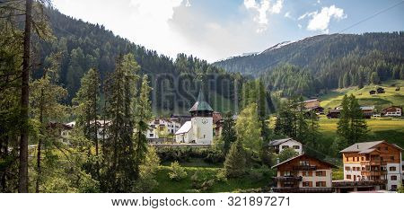Old Church On A Wooded Mountain At Blue Sky In The Swiss Alps