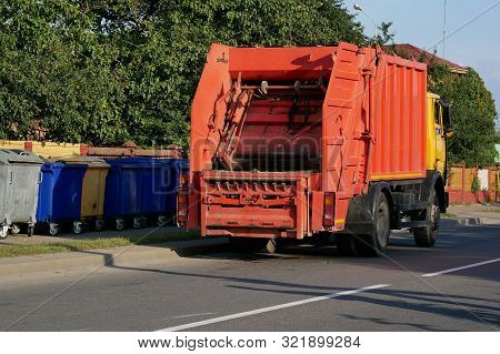 The Mechanical Garbage Truck Near Garbage Containers