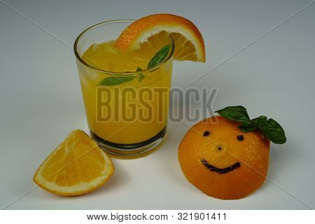 A Glass Of Fresh Orange Juice On White Table