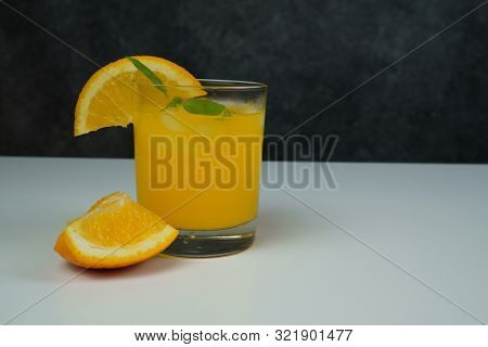 A Glass Of Fresh Orange Juice On White Table