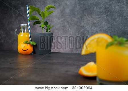 A Glass Of Fresh Orange Juice On Grey Background.
