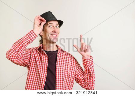 Excited Funny Man Pointing Finger Up At Copyspace. Happy Guy Wears Hat And Plaid Shirt. Guy Showing