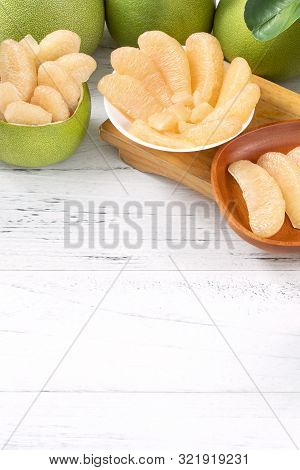 Fresh Peeled Pomelo, Pummelo, Grapefruit, Shaddock On Bright Wooden Table Background. Seasonal Fruit