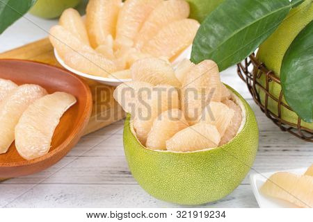 Fresh Peeled Pomelo, Pummelo, Grapefruit, Shaddock On Bright Wooden Table Background. Seasonal Fruit