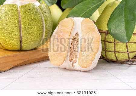 Fresh Peeled Pomelo, Pummelo, Grapefruit, Shaddock On Bright Wooden Table Background. Seasonal Fruit