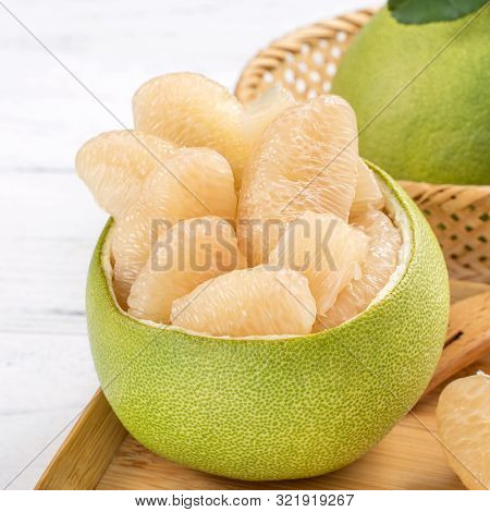 Fresh Peeled Pomelo, Pummelo, Grapefruit, Shaddock On Bright Wooden Table Background. Seasonal Fruit