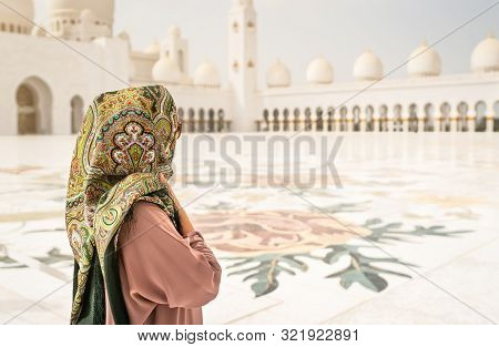 Back View Of Woman In The Sheikh Zayed Grand Mosque. Traditional Muslim Building In The United Arab 