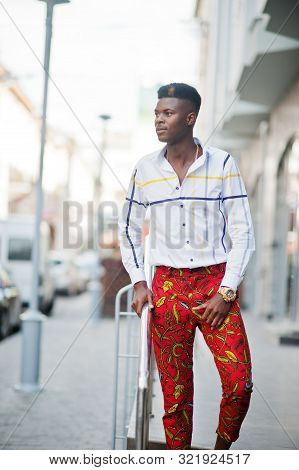 Portrait Of Handsome Stylish African American Model Man In Red Throusers And White Shirt.