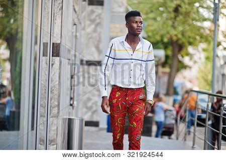 Portrait Of Handsome Stylish African American Model Man In Red Throusers And White Shirt.